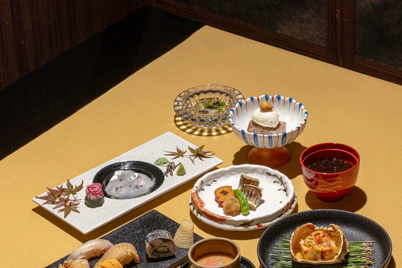 A private room at Sushi Oribe set with a full omakase course